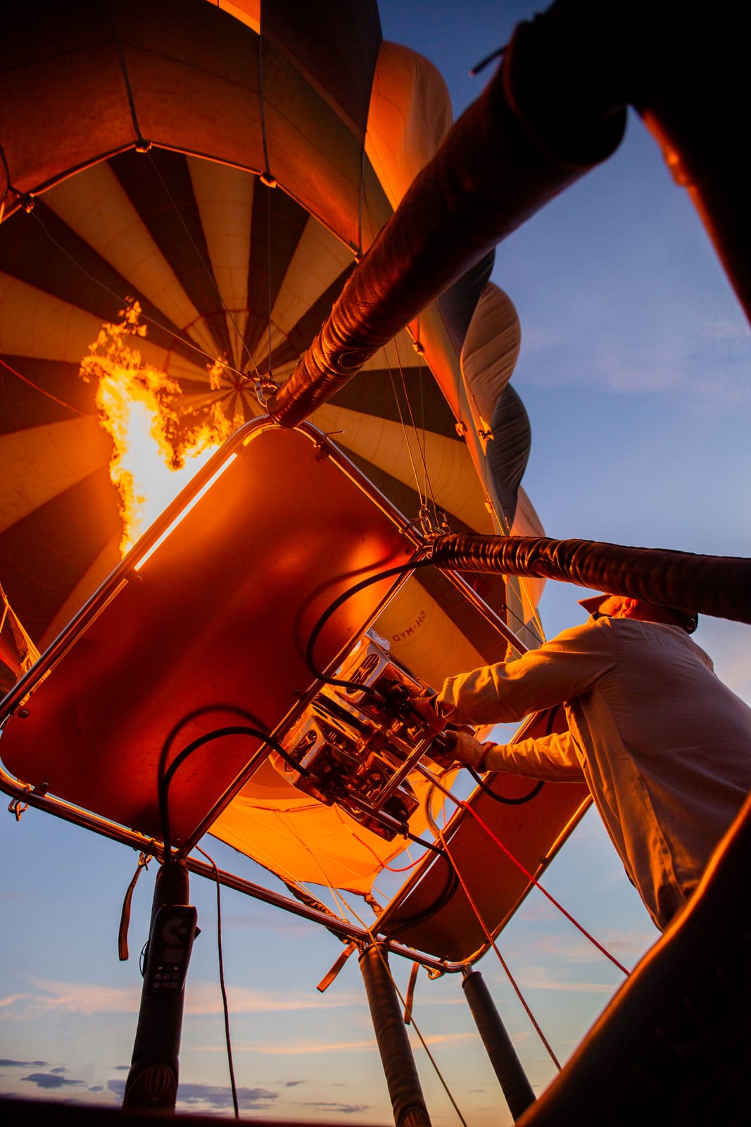 Looking up into a hot-air balloon as the burner fires