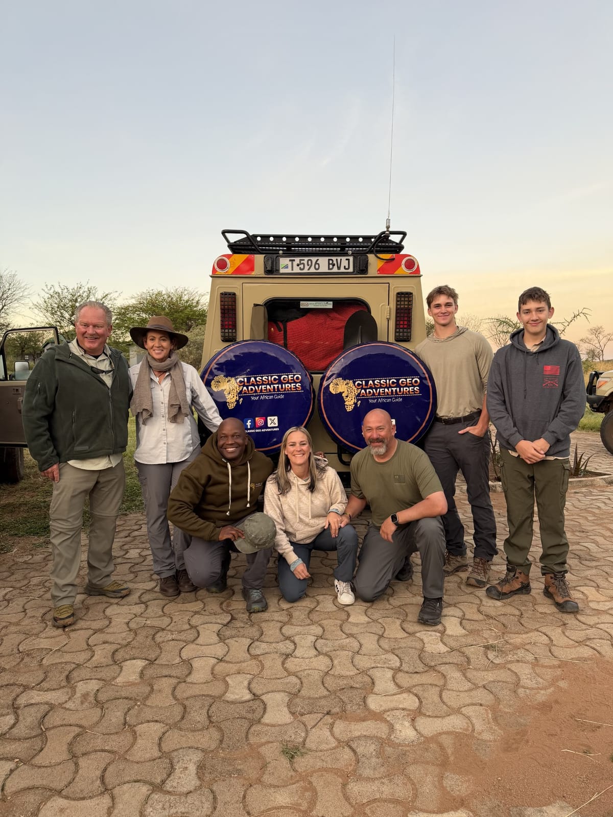 A safari group with their Classic Geo Adventures vehicle